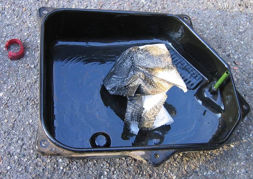 Old fluid and debris drained from a transmission pan